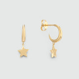 A pair of gold-toned dangle earrings on a light gray background. One earring is shown front-facing with a five-pointed star, and the other is shown from the side/back, displaying a crescent moon shape with a small hanging star.